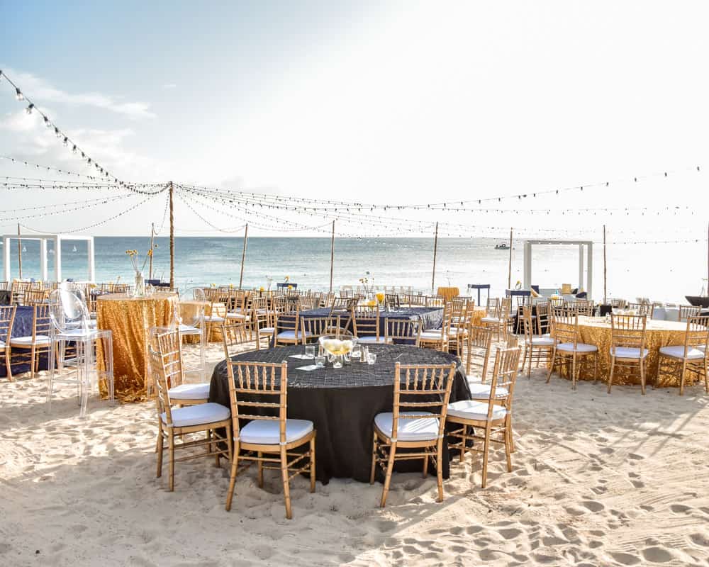 Black and gold decor for corporate beach event, Celebrations Cayman Wedding and Event Planners